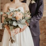 woman holding beige-petaled flower bouquet