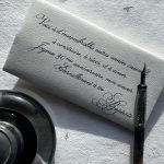 Calligraphy on envelope with ink pen and inkwell.