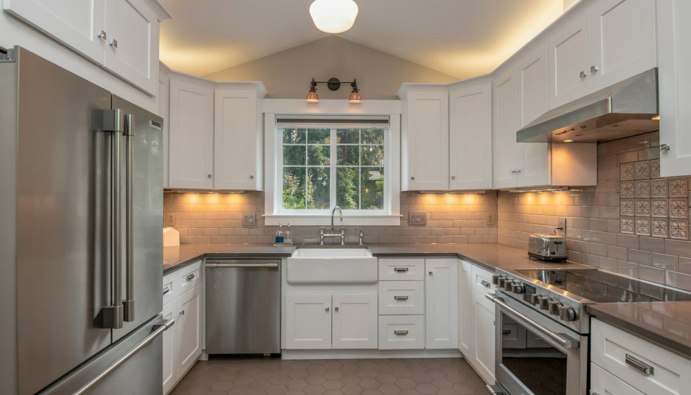 white wooden kitchen cabinet with white pendant lamp