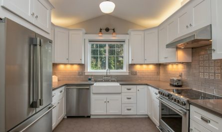 white wooden kitchen cabinet with white pendant lamp