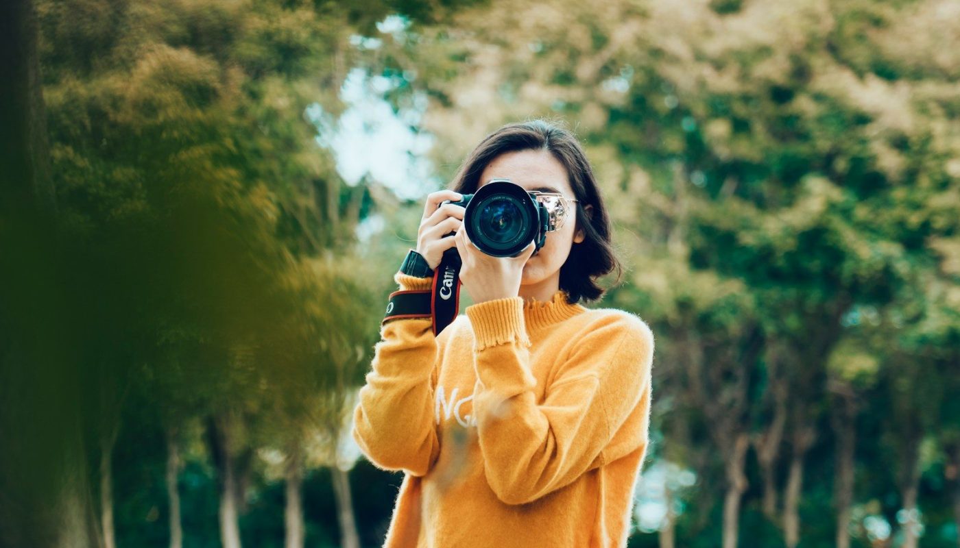 woman holding DSLR camera