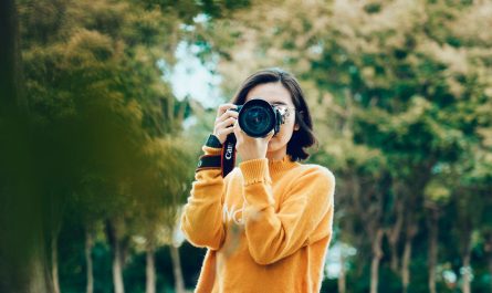 woman holding DSLR camera