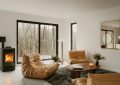 Modern living room with fireplace and forest view