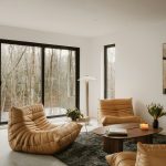 Modern living room with fireplace and forest view