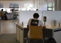 A person sitting at a desk with a laptop